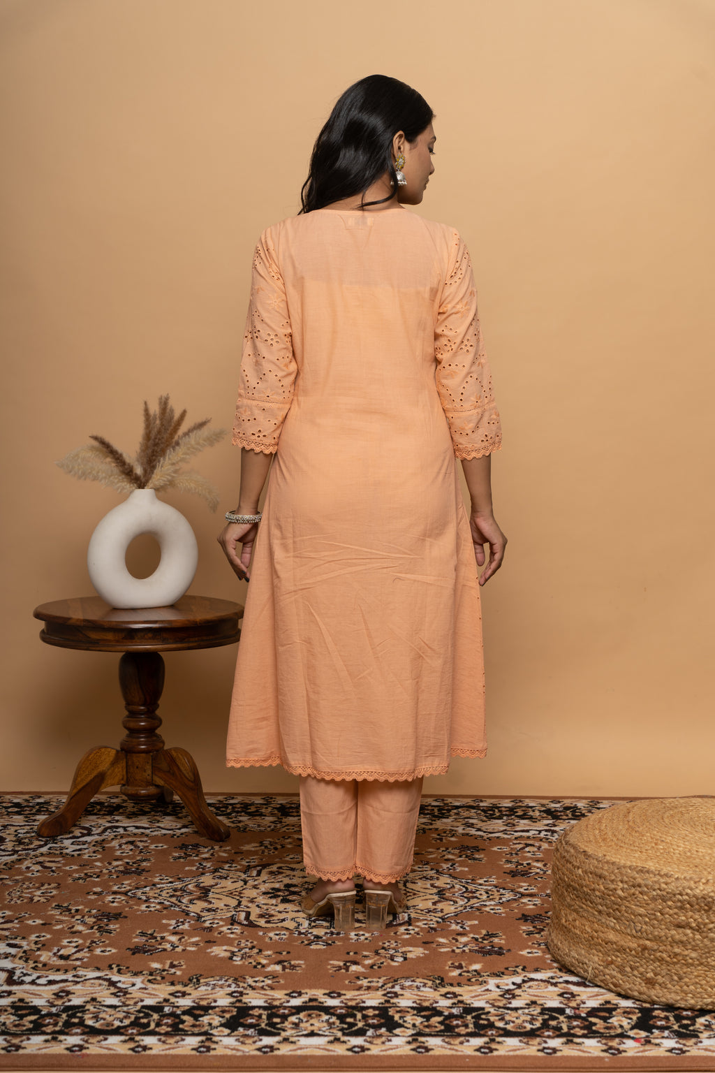 Back view of women’s orange cotton suit set by Poshida