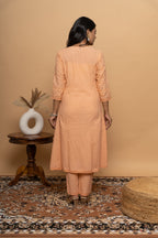 Back view of women’s orange cotton suit set by Poshida