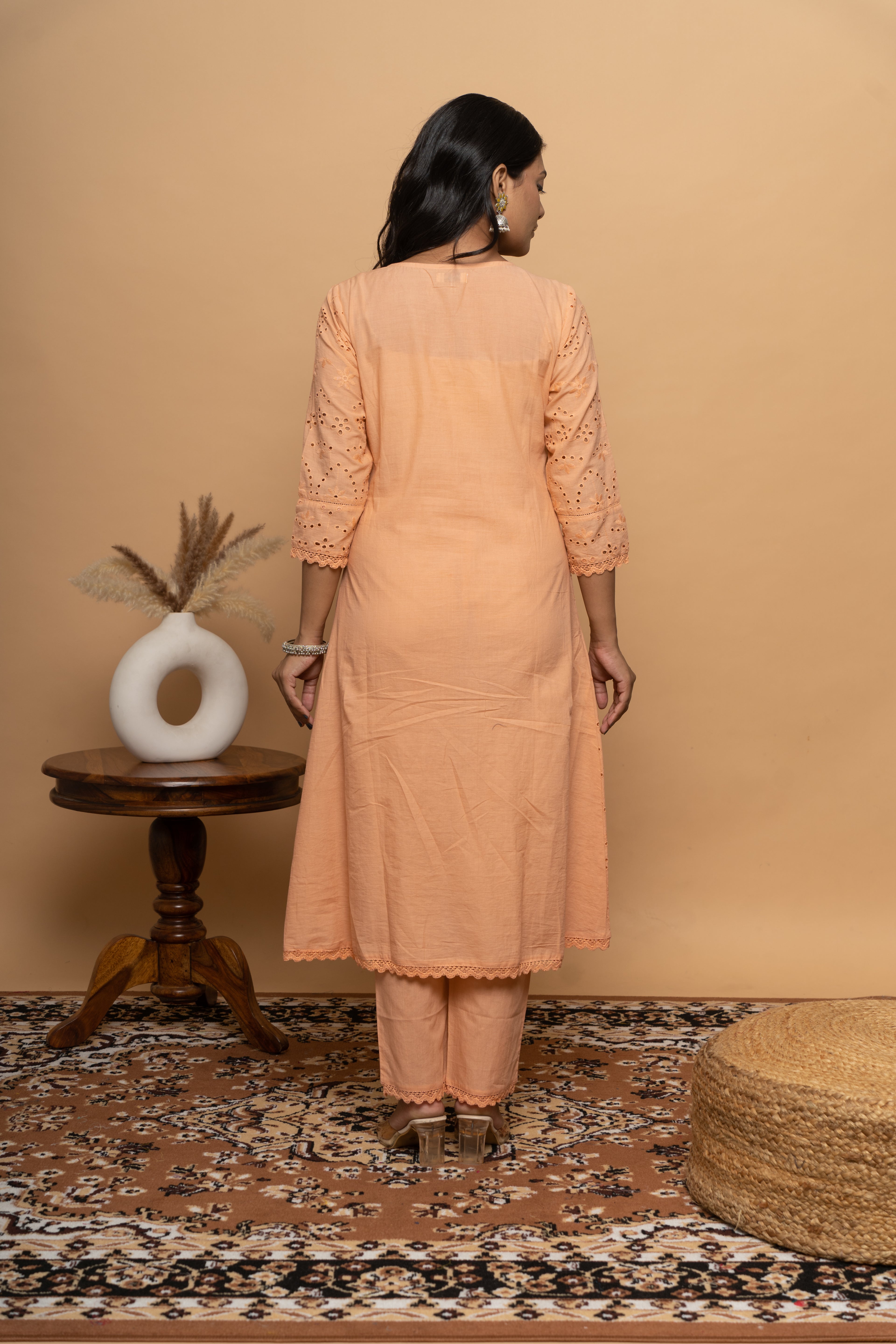 Back view of women’s orange cotton suit set by Poshida