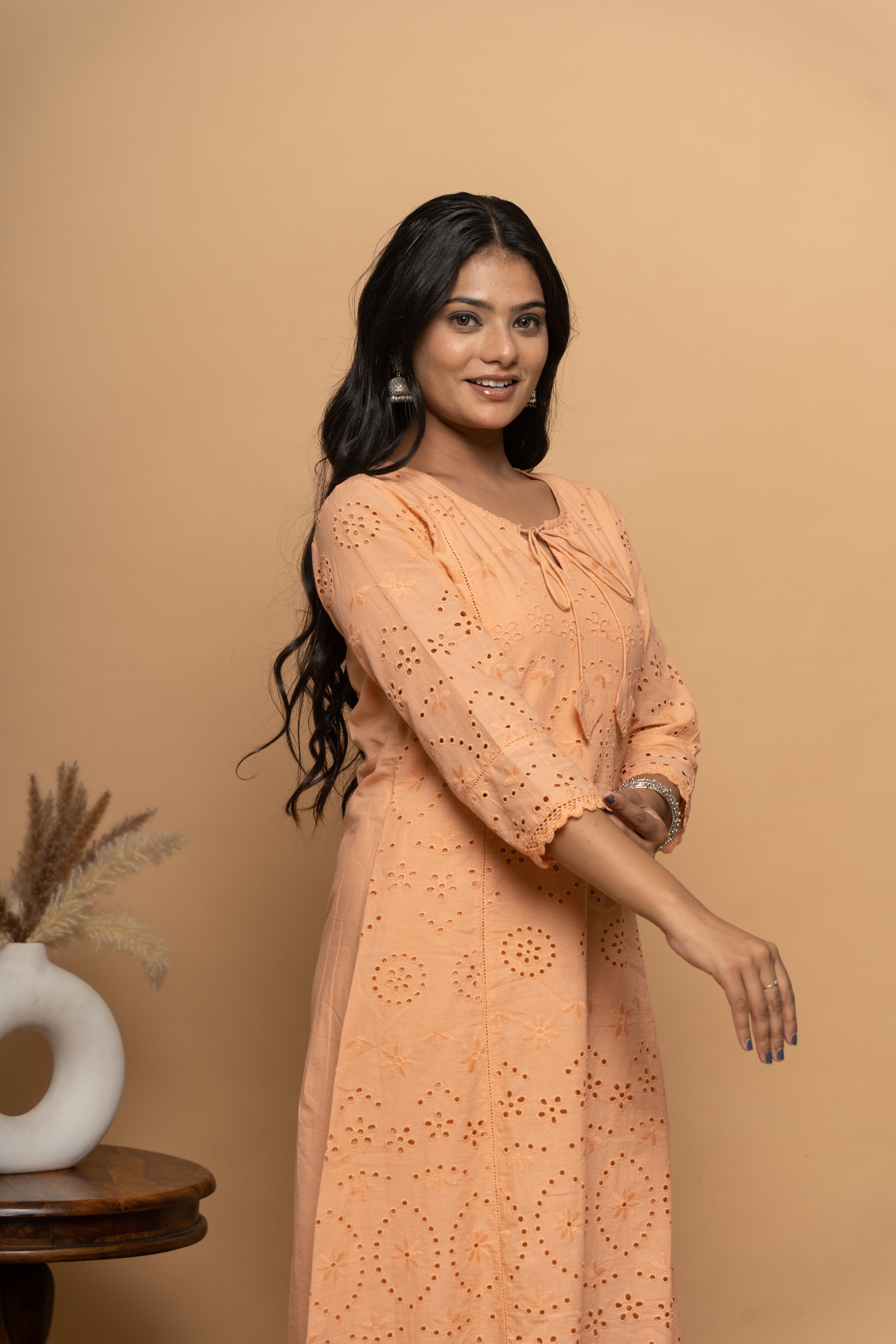 Side view of orange cotton suit set for women by Poshida