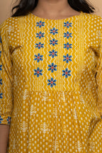 Close-up embroidery and fabric detail on mustard cotton suit set by Poshida