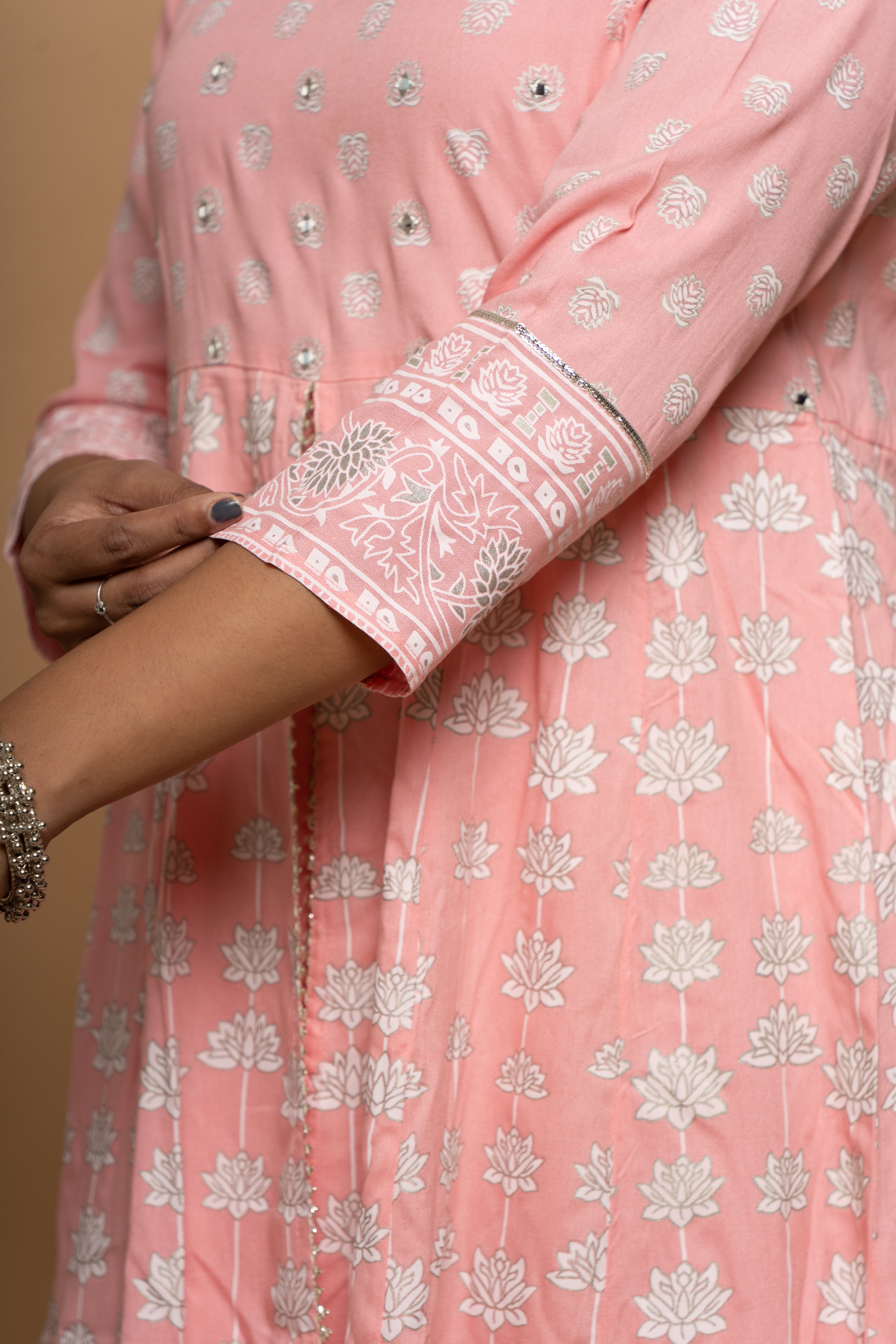 Close-up embroidery and fabric detail on light pink cotton suit set by Poshida
