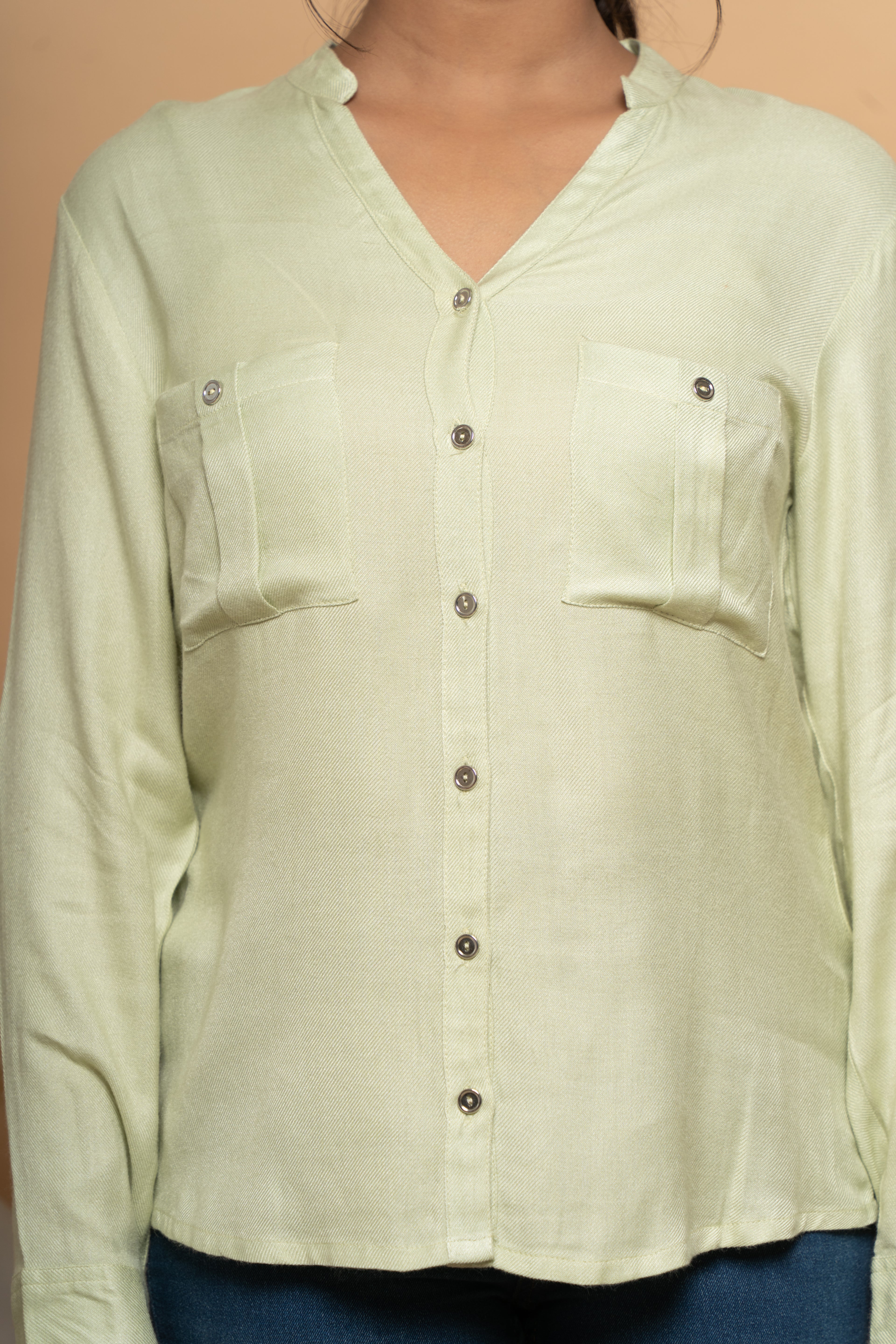 Close-up stitching detail on classic green shirt by Poshida