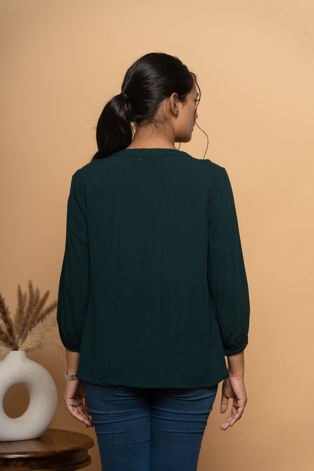 Back view of women’s dark green embroidered top by Poshida