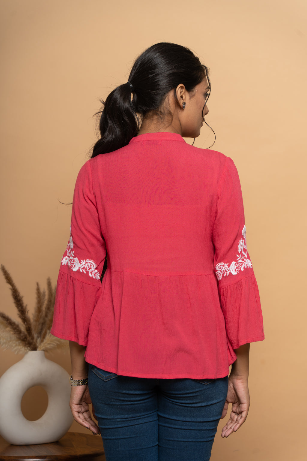 Back view of women’s elegant red embroidered top by Poshida