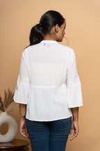 Back view of women’s white schiffli flared top by Poshida