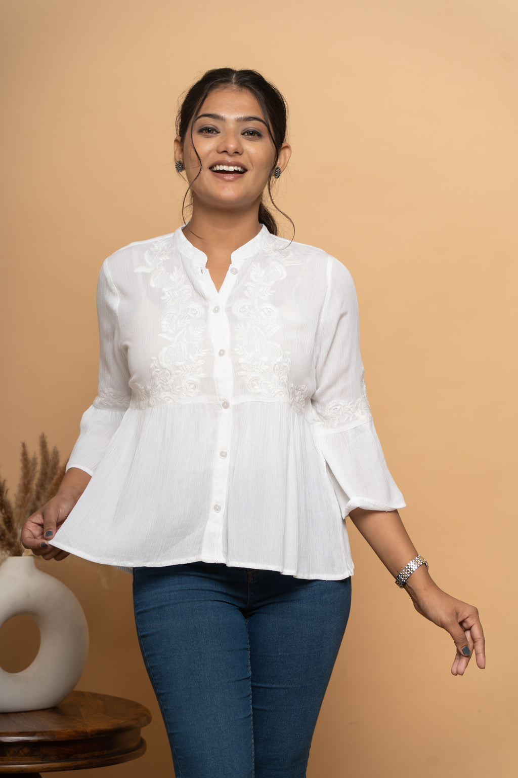 Fabric texture of white schiffli flared top by Poshida