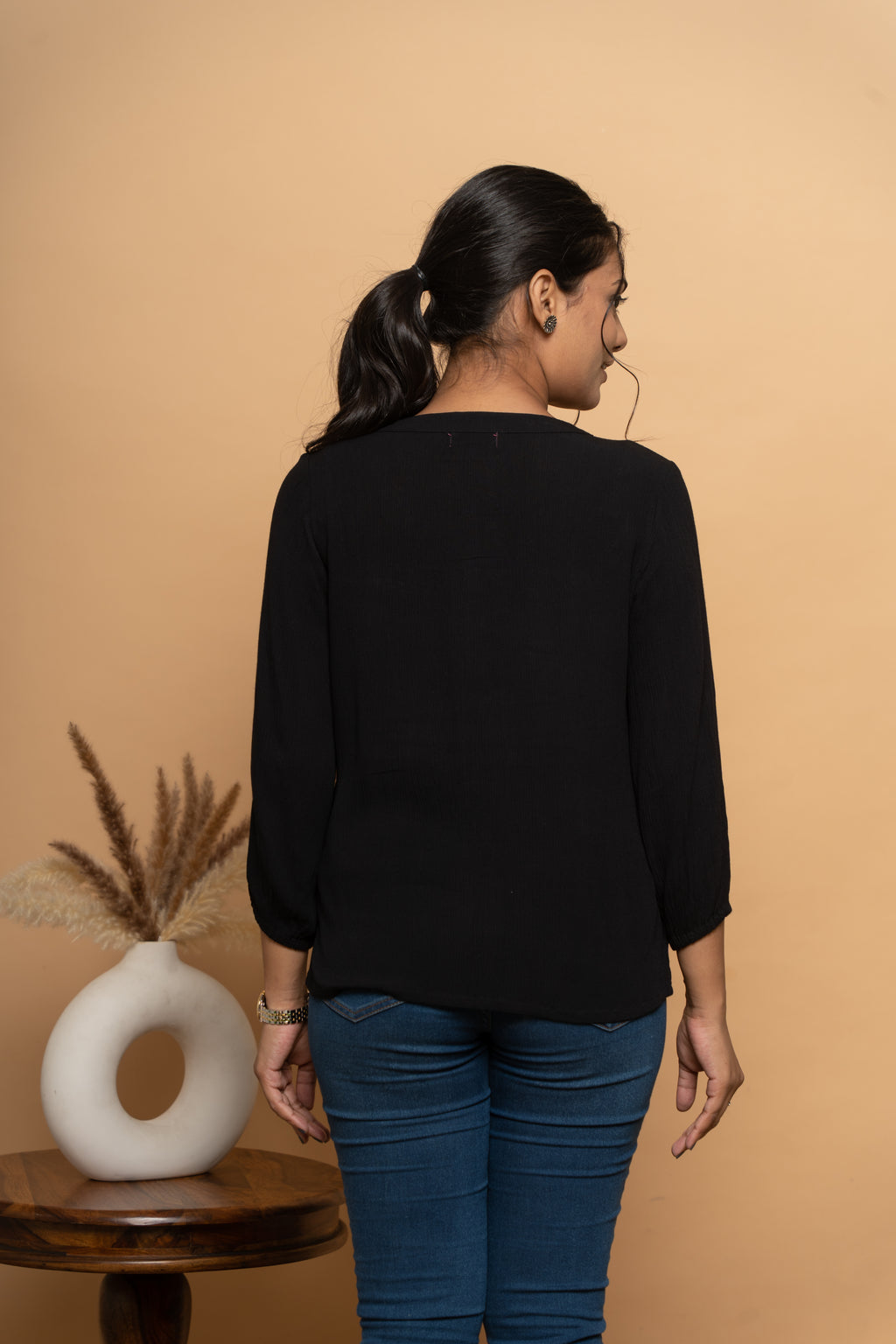 Back view of women’s indigo embroidered top by Poshida