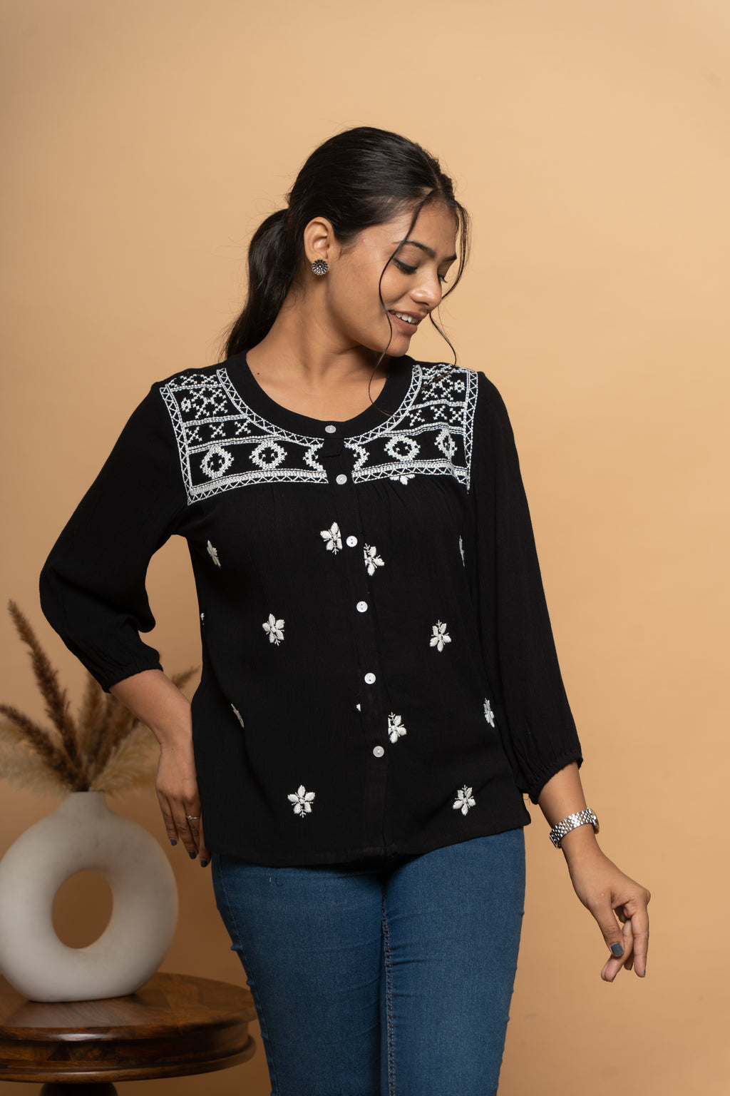 Side view of indigo embroidered women’s top by Poshida