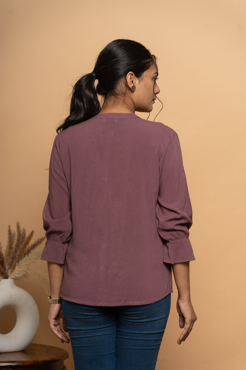 Back view of women’s purple embroidered top by Poshida