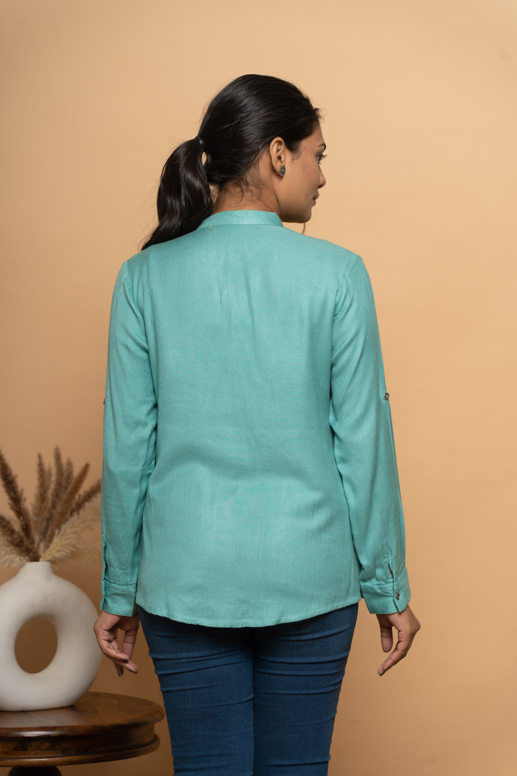 Back view of women’s light blue embroidered shirt by Poshida