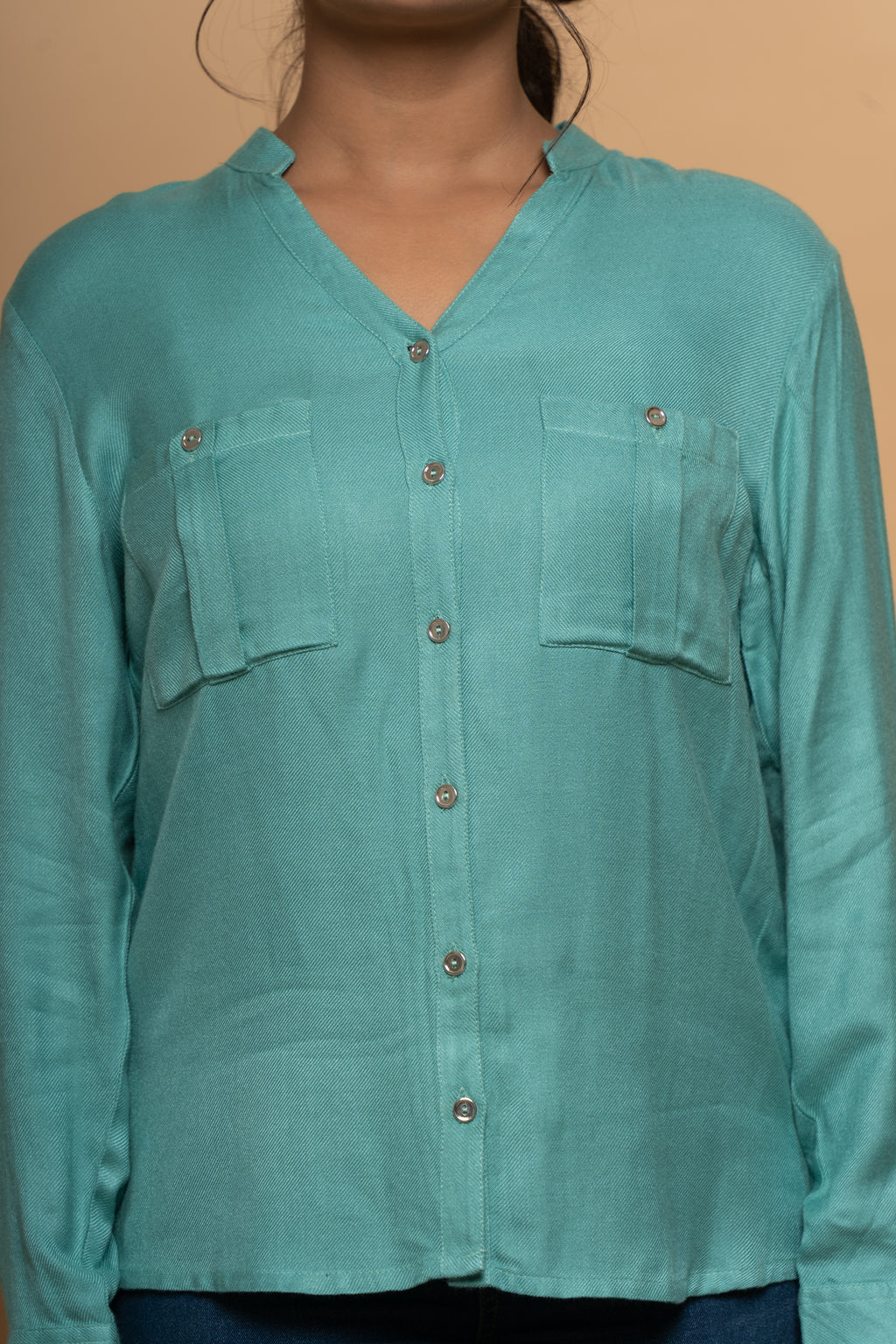 Close-up embroidery detail on light blue shirt by Poshida