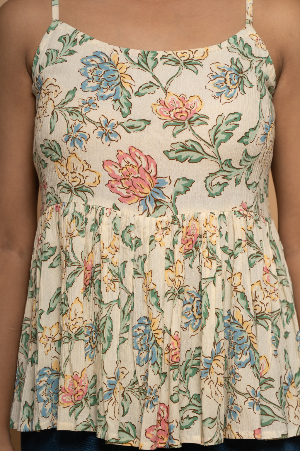 Close-up floral print detail on sleeveless flared top by Poshida