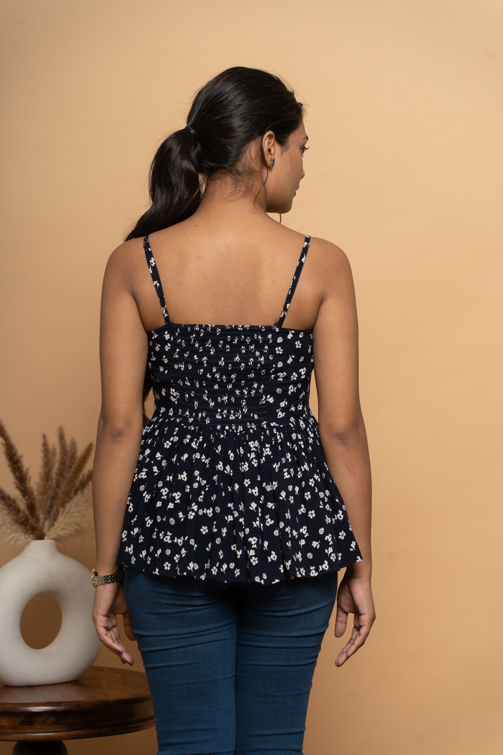 Back view of women’s sleeveless indigo printed flared top by Poshida